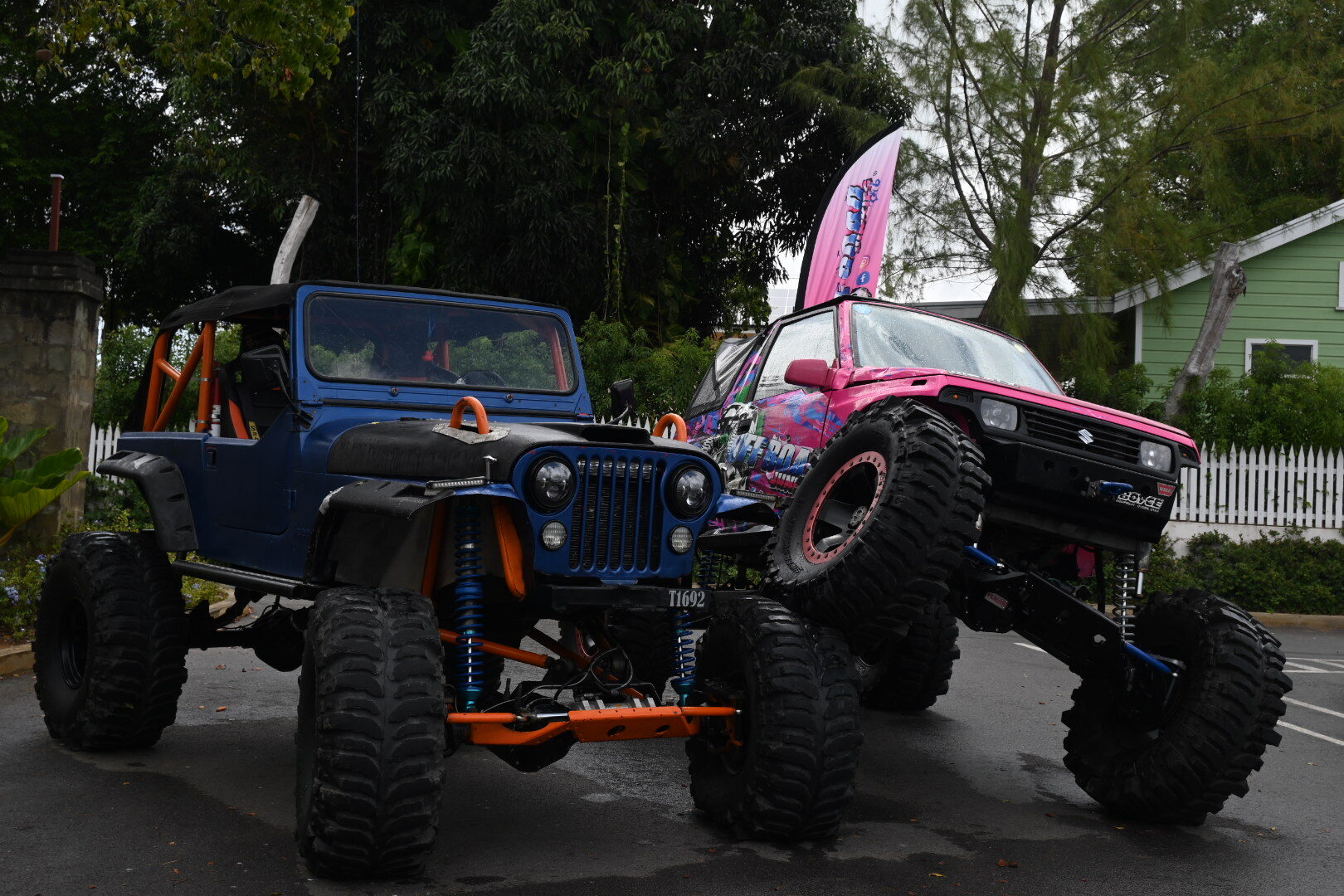 Two lifted off-road vehicles parked at Haymans Market