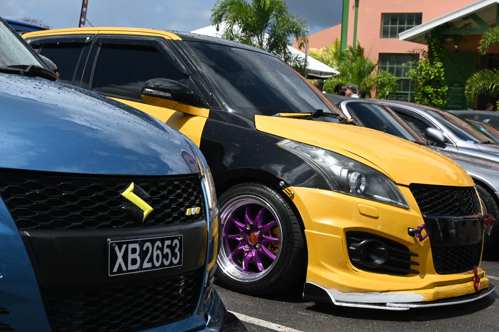 Blue and yellow modified cars parked together at Haymans Market
