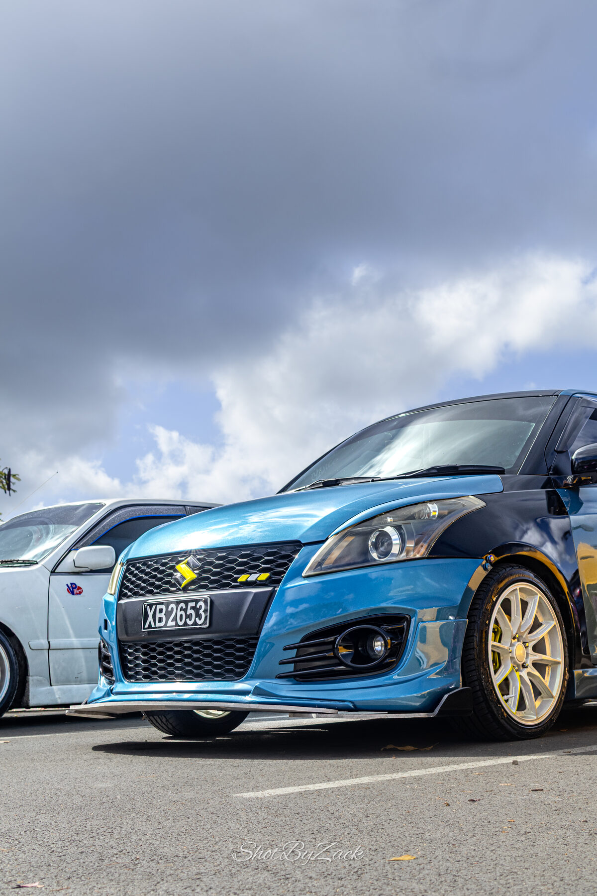 Blue and yellow modified hatchbacks photographed at Haymans Market
