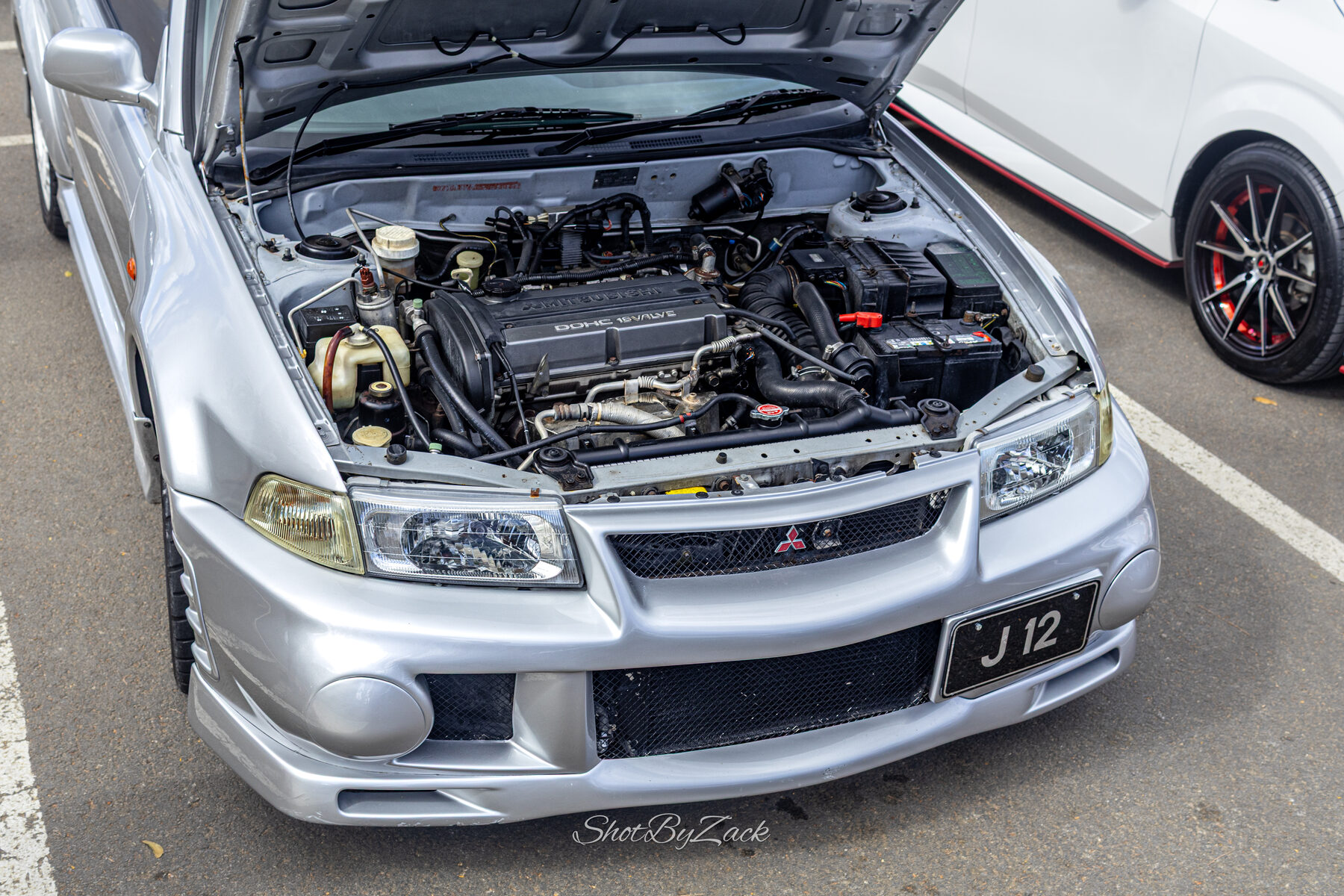 Open engine bay on display at Cars and Coffee Barbados