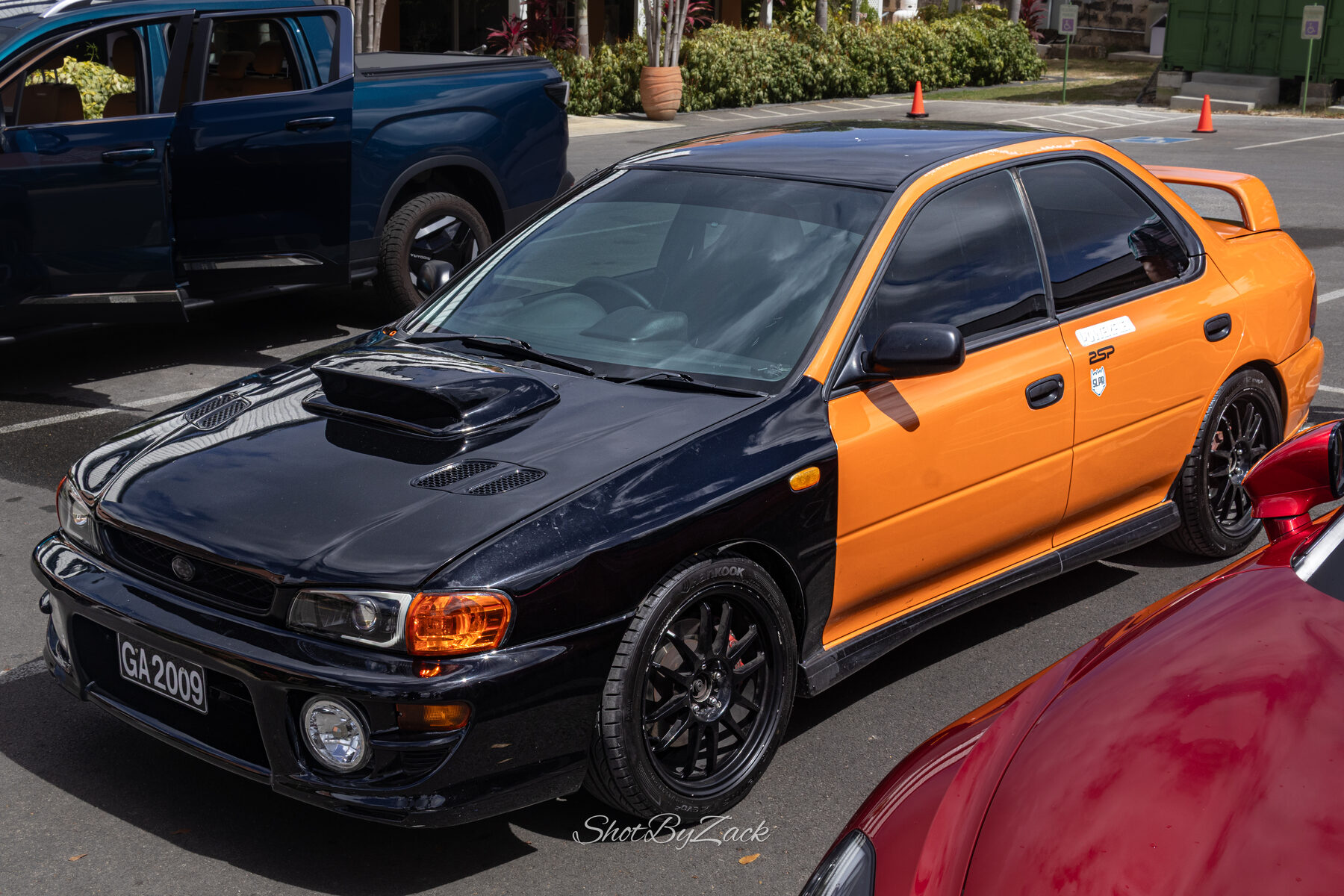 Orange Subaru photographed at Cars and Coffee Barbados